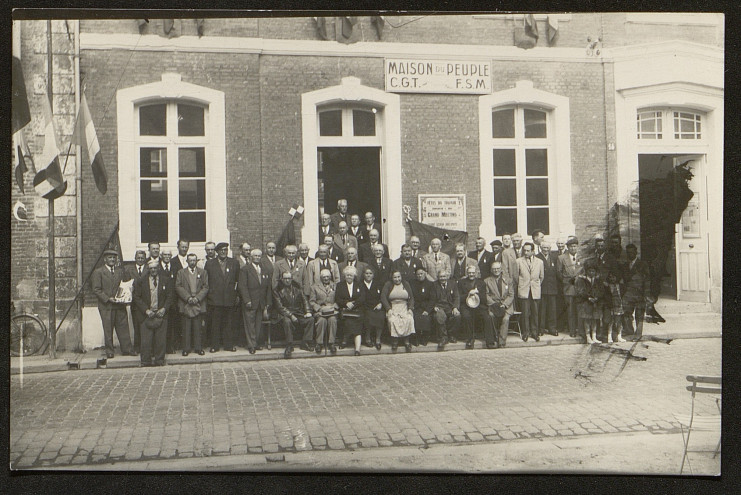 Photographie d'un groupe de personnes posant devant la maison du peuple CGT FSM de Lisieux.